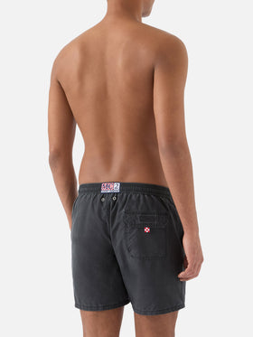 Patmos swim shorts in black with used effect and logo embroidery